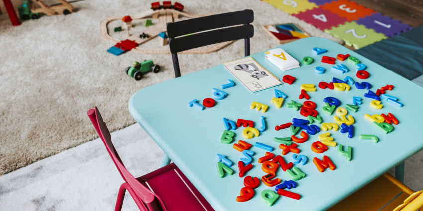 an indoor children's play area with toys and chairs but no people
