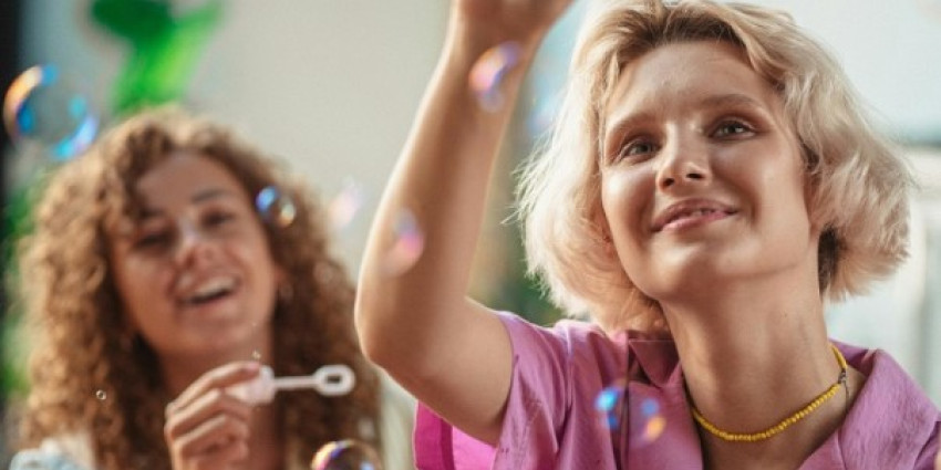 two women blowing bubbles