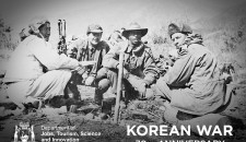 4 soldiers sitting in a field during the Korean War