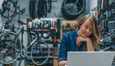 Girl in a workshop looking at a laptop