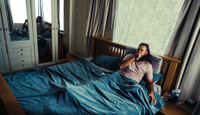 Photograph of a man bedridden with flu