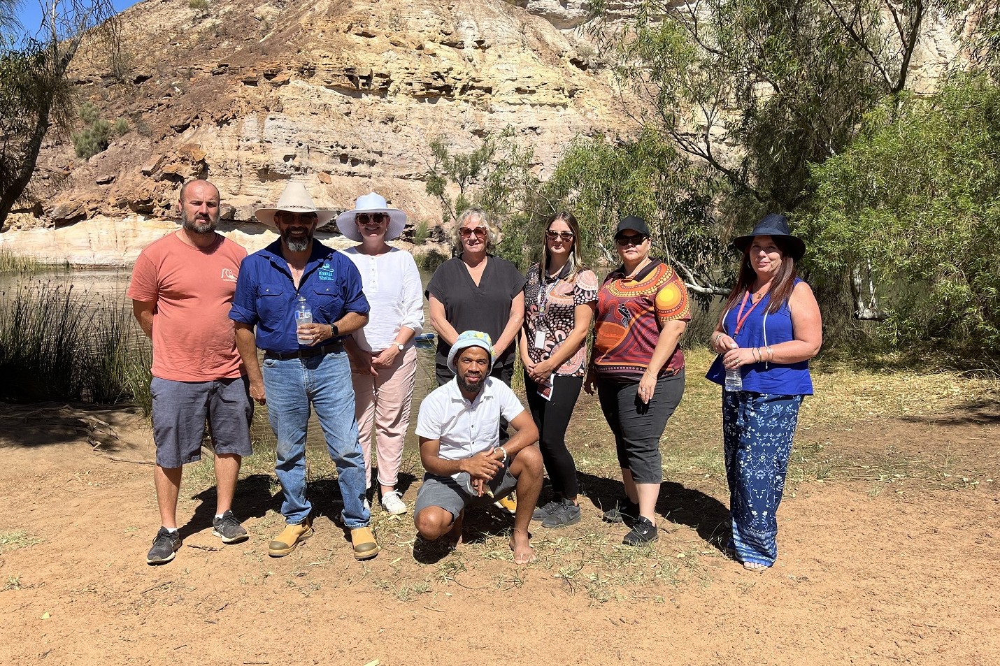 Photo of a group of Communities staff in a natural landscape