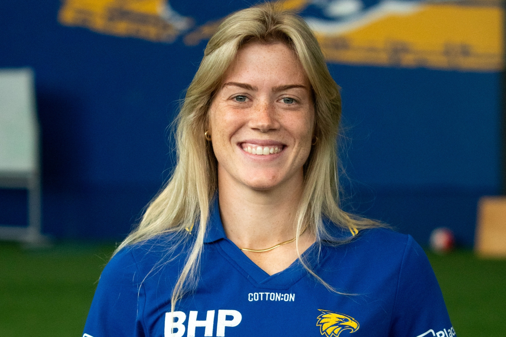 A woman with long hair wearing a sports top