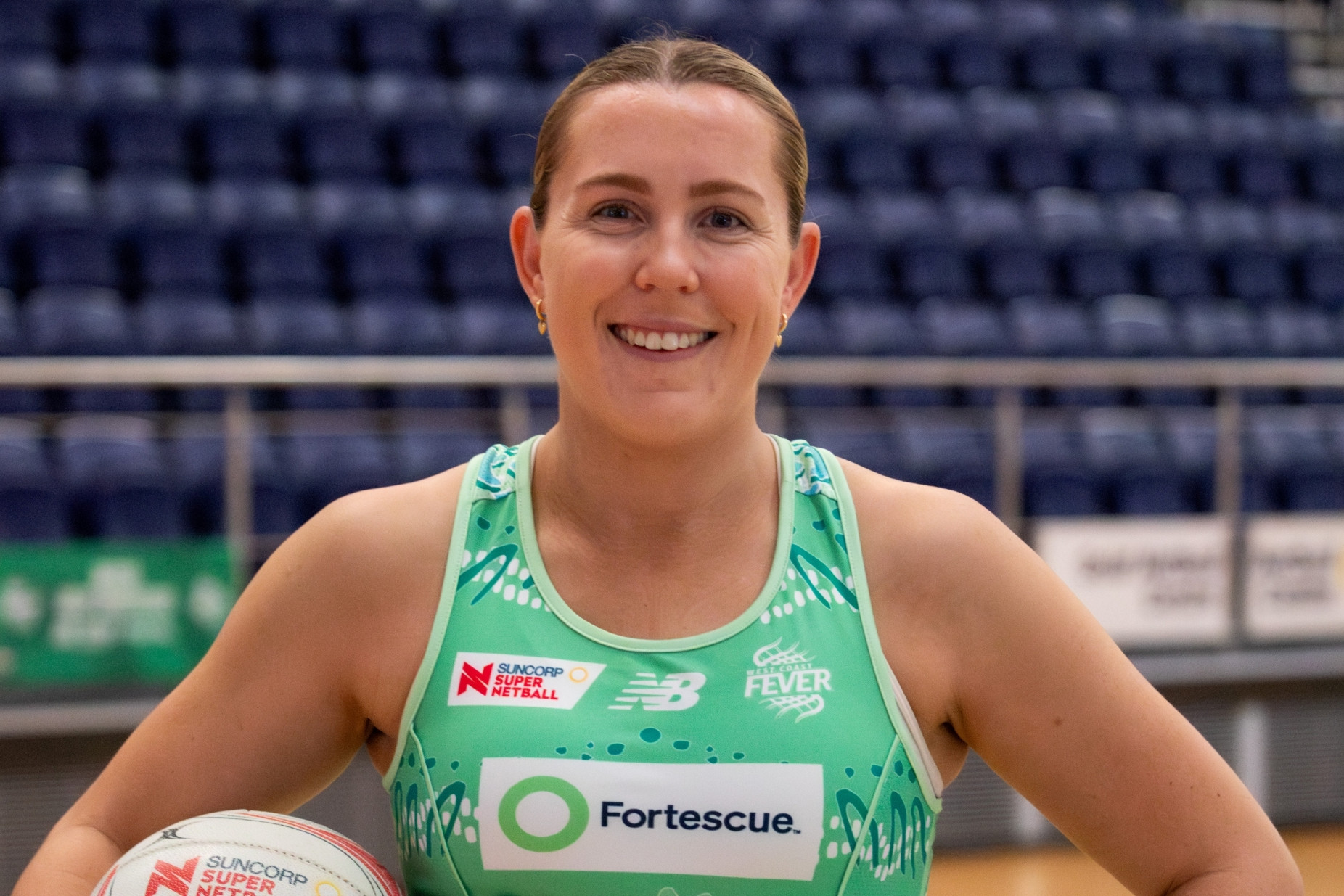 A woman in basketball clothes on a basketball court