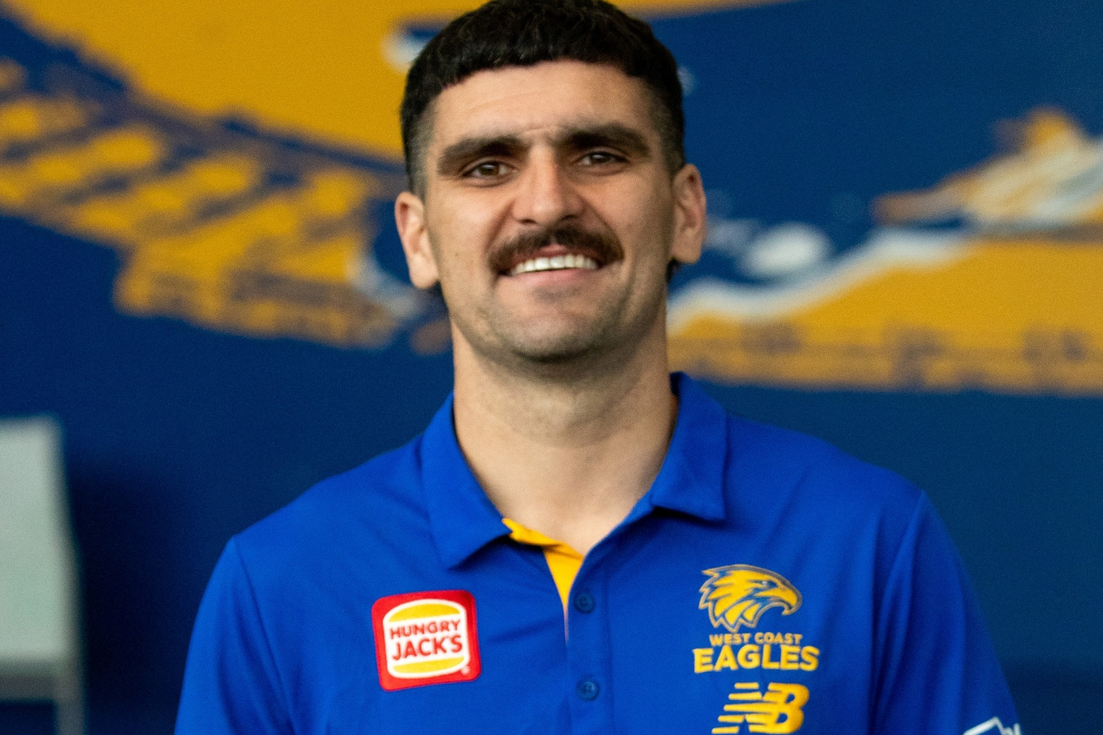 A footballer wearing a west coast eagles top