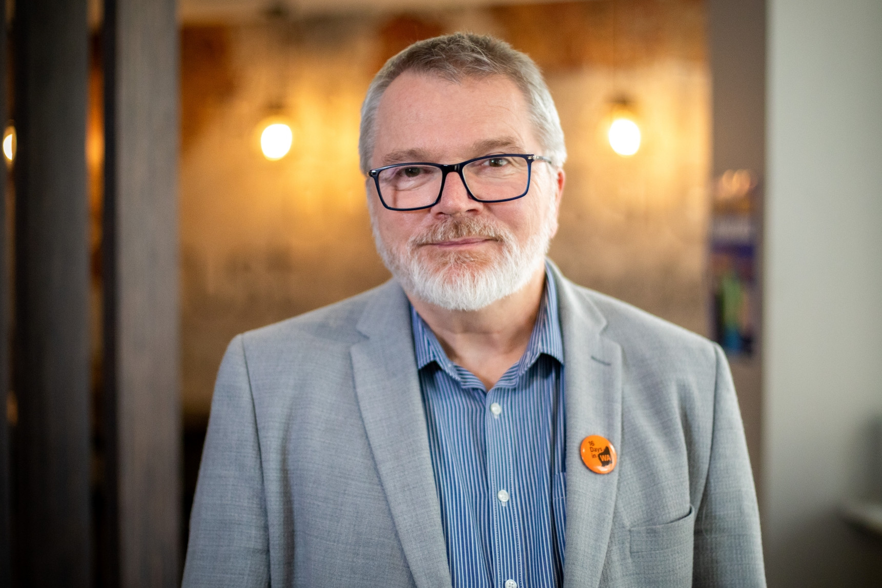 A professionally dressed man in an office working environment
