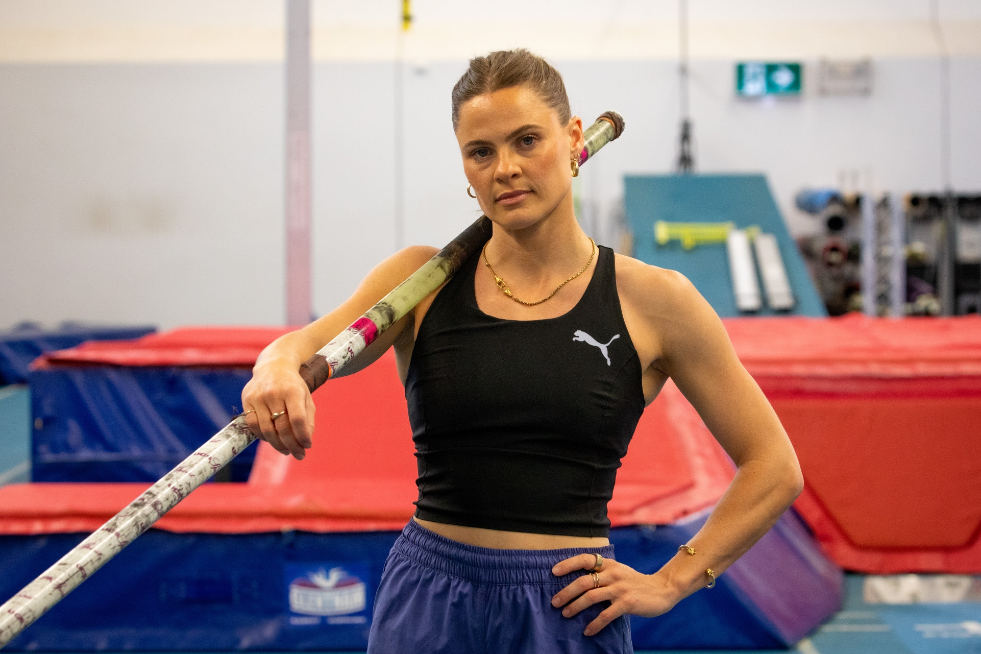 A young sportswoman holding a pole vault