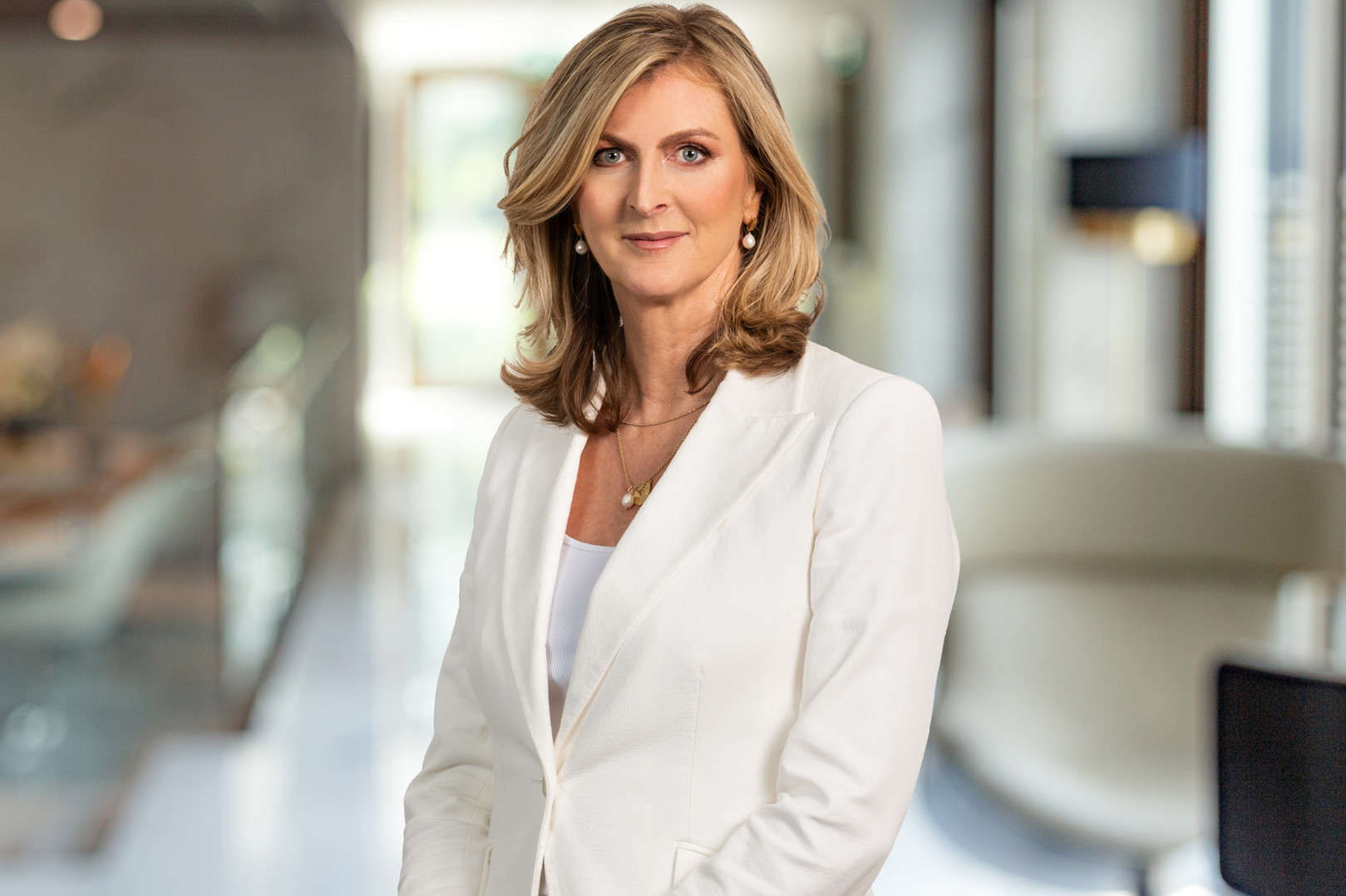 A professionally dressed woman in an office environment