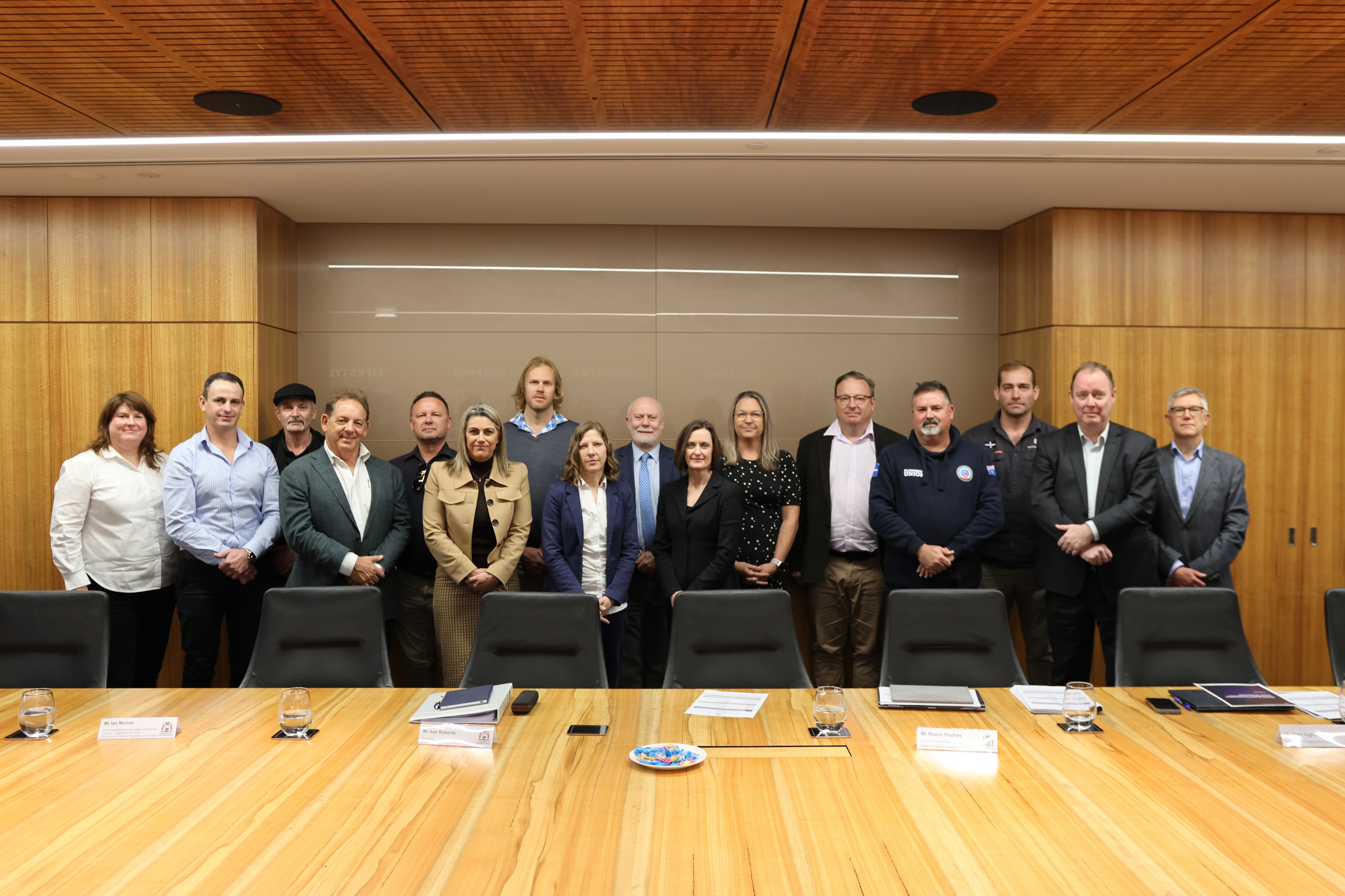 Committee members standing in board room