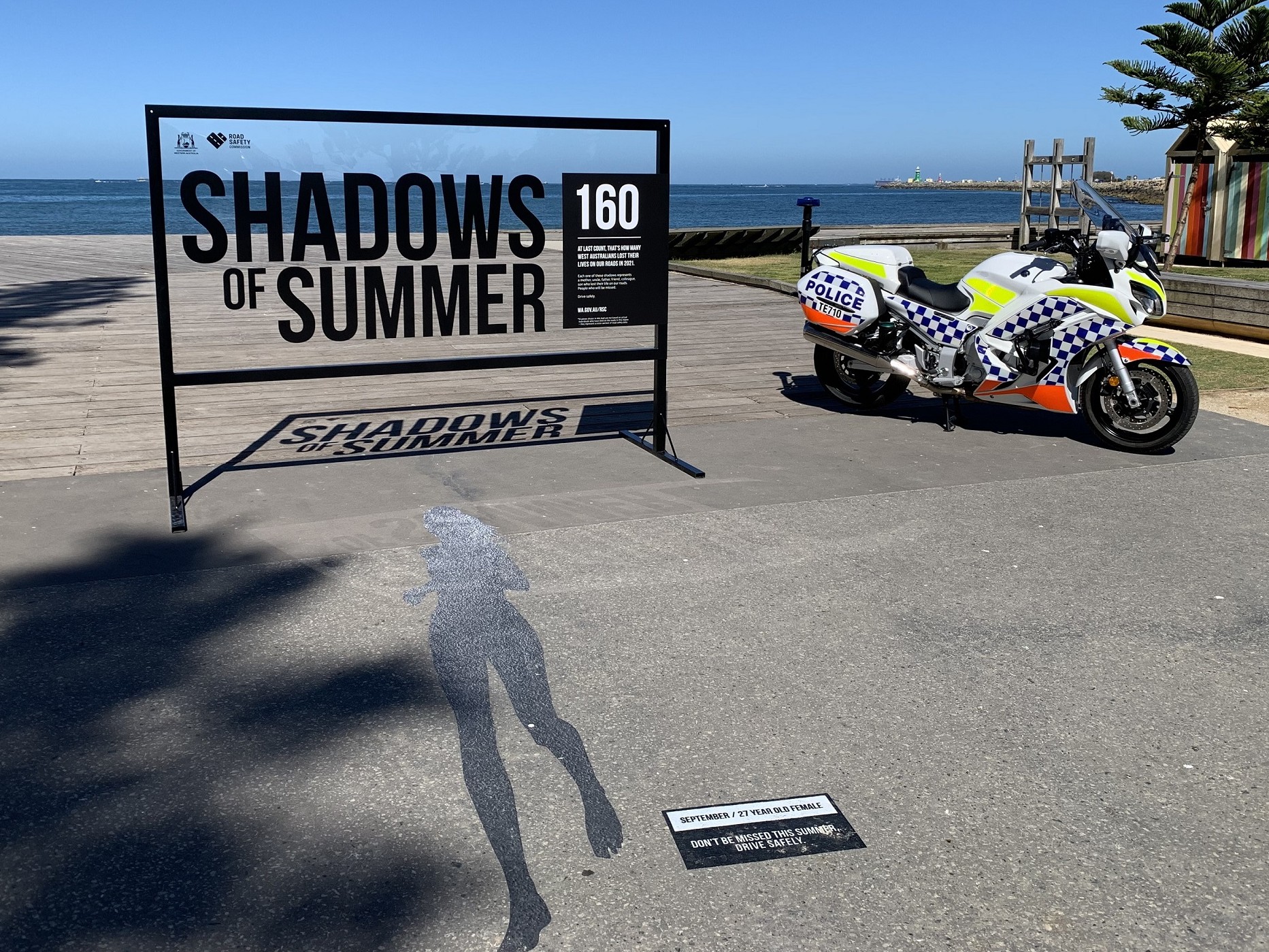 Police bike next to shadow on ground