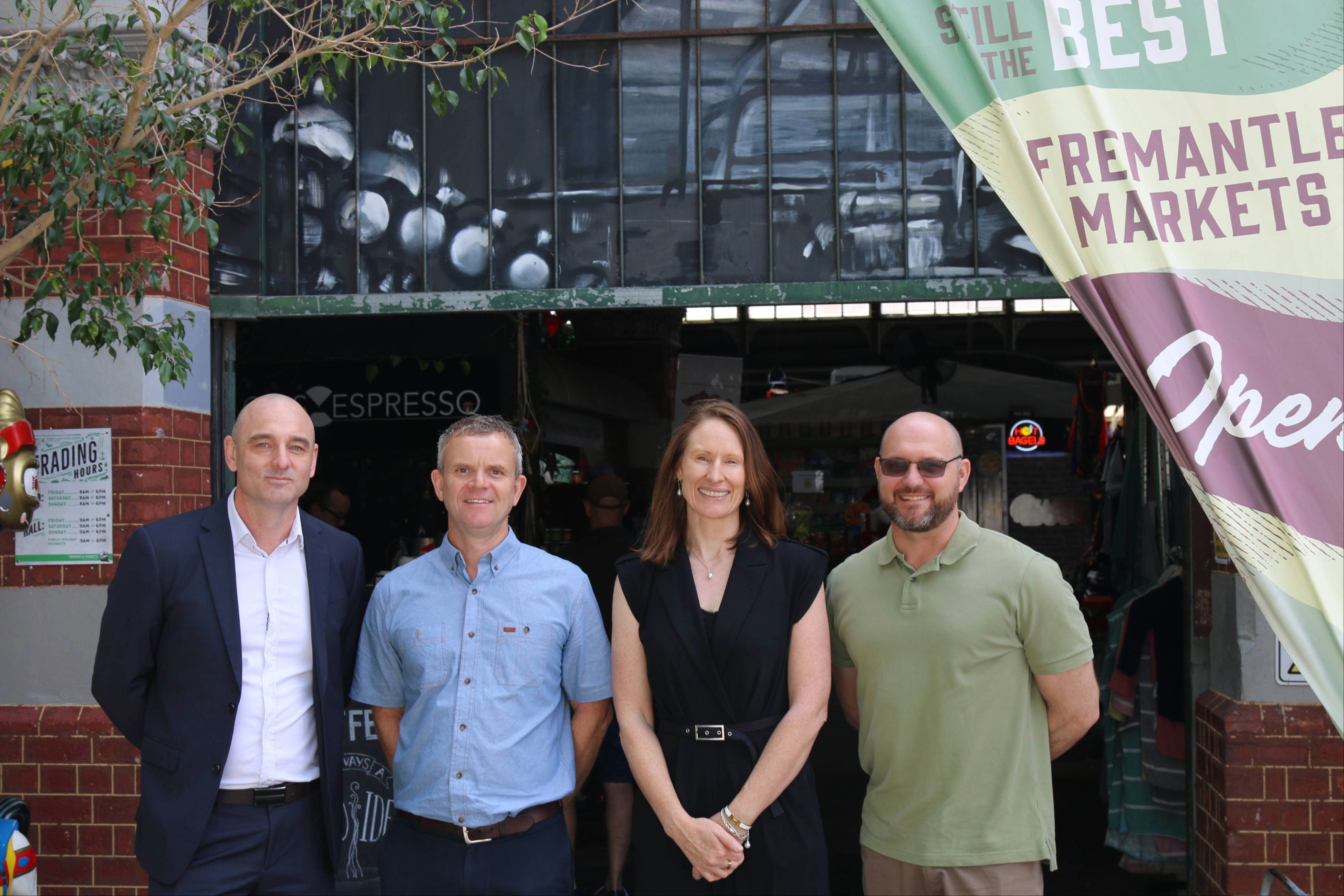 Four people standing at the entrance of Fremantle Markets