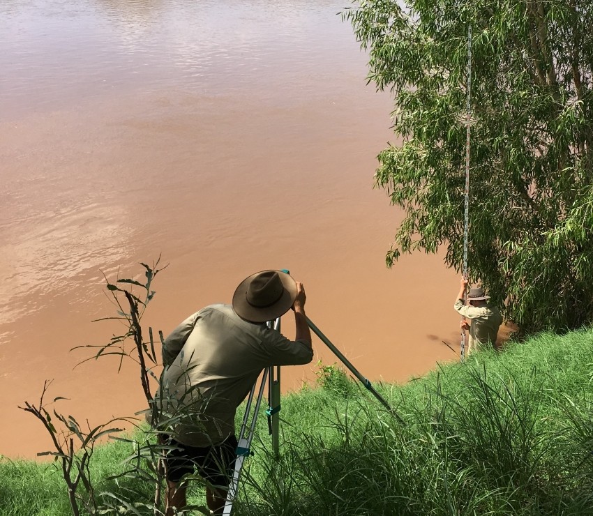 Field officers measuring flood levels at Margaret River in Fitzroy catchment