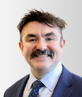 DPC Director General Michael Carey looking at the camera and smiling