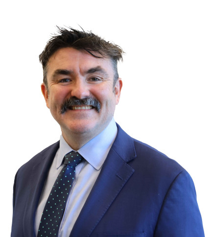 DPC Director General Michael Carey looking at the camera and smiling